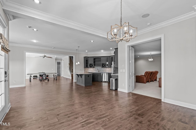 living area featuring dark wood finished floors, crown molding, recessed lighting, and ceiling fan with notable chandelier