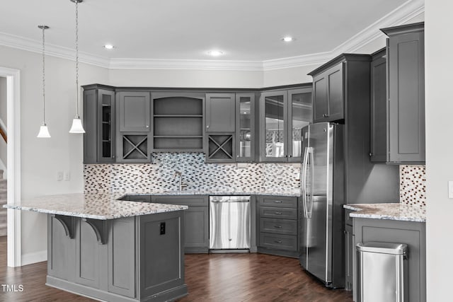 kitchen with appliances with stainless steel finishes, glass insert cabinets, dark wood finished floors, and gray cabinetry