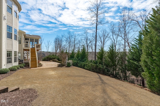 view of yard featuring stairs, a patio, and fence