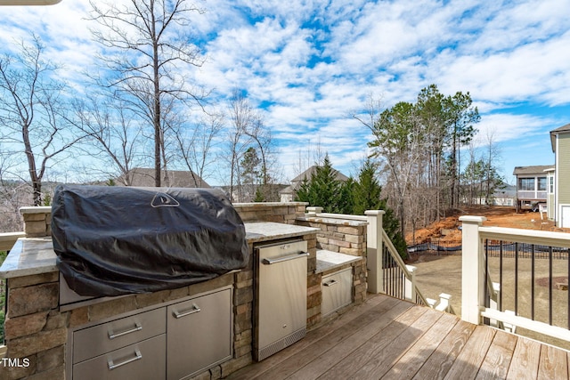 deck with grilling area and an outdoor kitchen