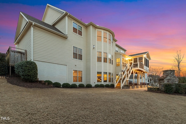 property at dusk with stairs