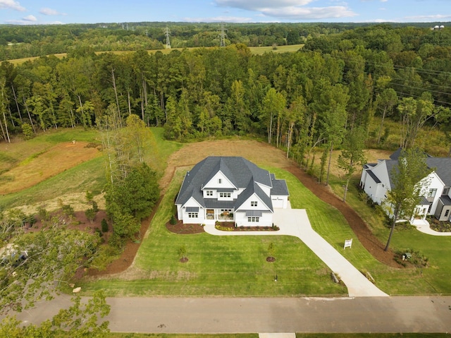 drone / aerial view featuring a view of trees