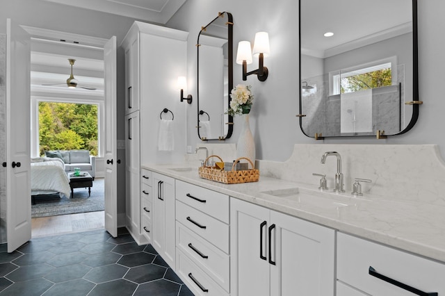 full bathroom with ensuite bath, a sink, and a healthy amount of sunlight