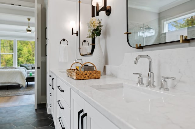 ensuite bathroom featuring tasteful backsplash, double vanity, a sink, and ensuite bathroom