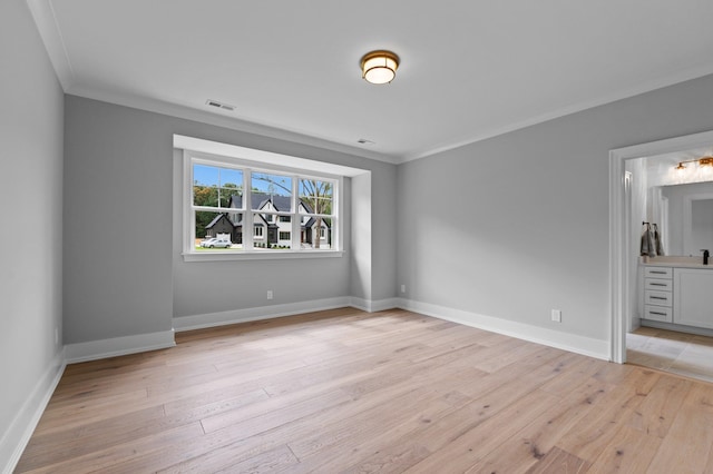 unfurnished bedroom featuring ornamental molding, light wood finished floors, and visible vents