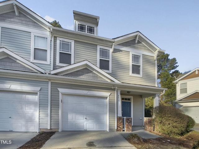 view of property featuring a garage and concrete driveway