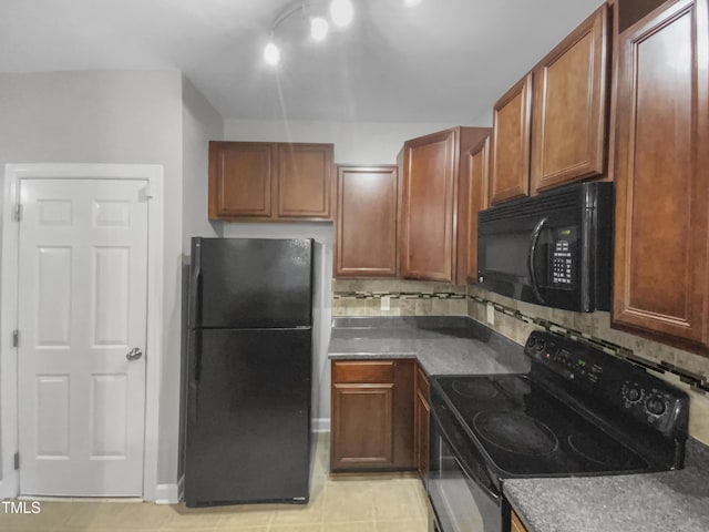 kitchen with black appliances, brown cabinetry, dark countertops, and decorative backsplash