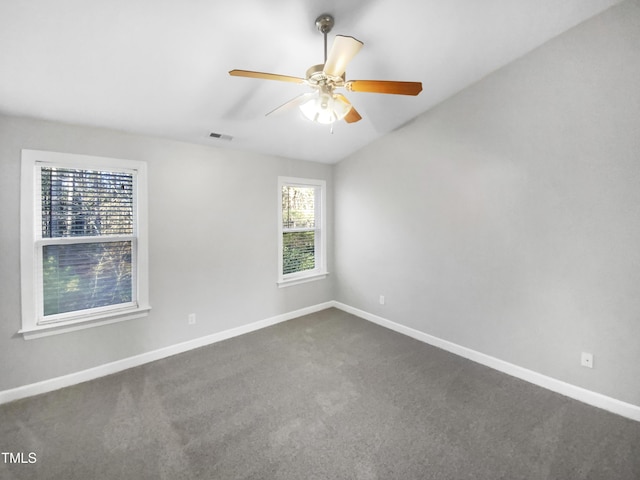 spare room with carpet floors, visible vents, and baseboards