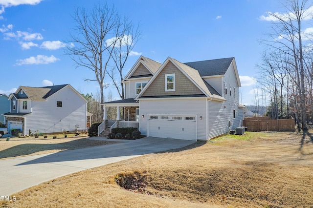 view of front of property with central air condition unit, concrete driveway, covered porch, fence, and a garage