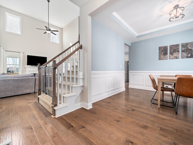 dining area with a wealth of natural light, stairs, and dark wood-style flooring