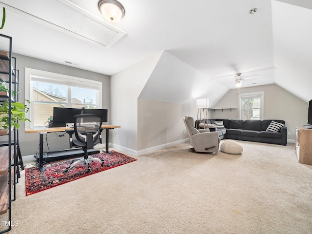 carpeted office featuring attic access, visible vents, baseboards, and vaulted ceiling