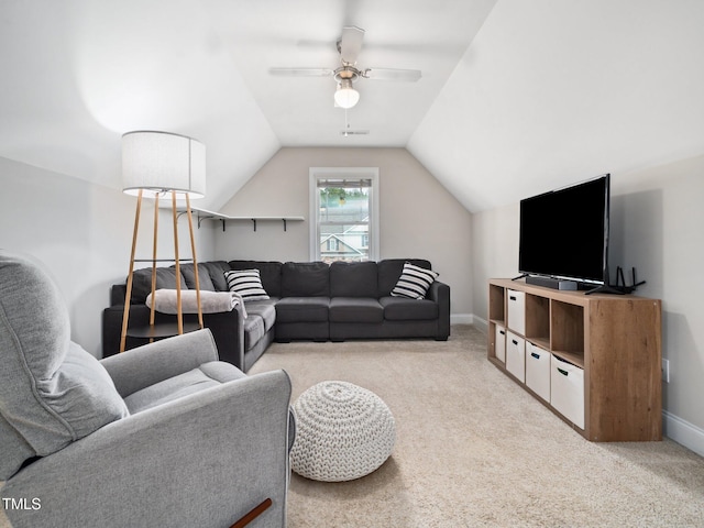 living area with light carpet, ceiling fan, baseboards, and lofted ceiling