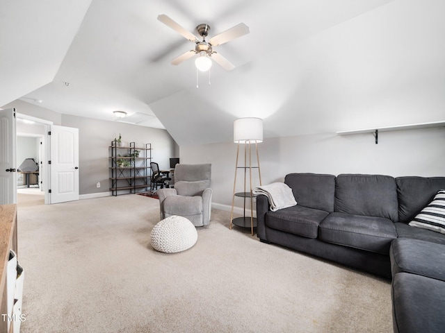 living area featuring vaulted ceiling, carpet floors, a ceiling fan, and baseboards