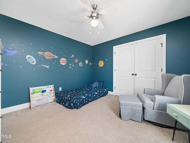 bedroom with carpet floors, ceiling fan, baseboards, and a closet