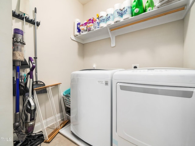 laundry area with tile patterned flooring, laundry area, and washing machine and clothes dryer