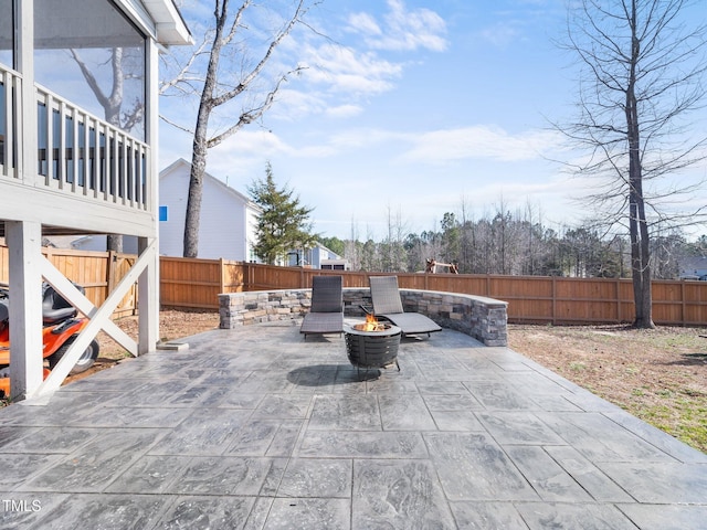 view of patio / terrace featuring an outdoor fire pit and a fenced backyard