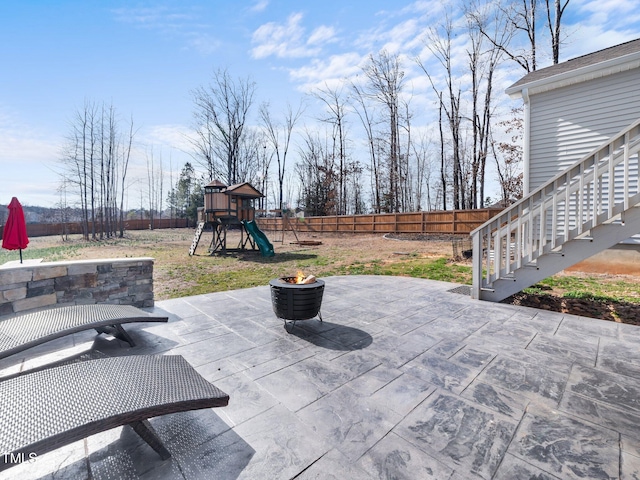 view of patio / terrace featuring a fenced backyard and a playground