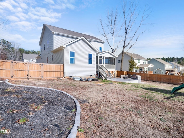 back of house with a residential view, a sunroom, a patio area, and a fenced backyard