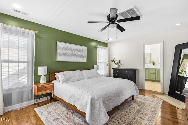 bedroom with visible vents, ceiling fan, baseboards, and wood finished floors