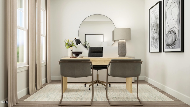 office featuring wood finished floors, a wealth of natural light, and baseboards