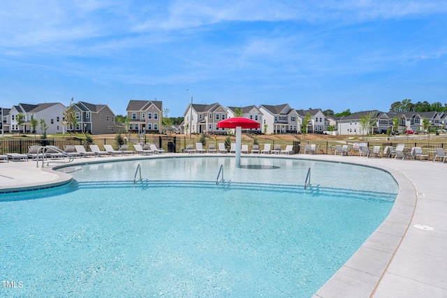 community pool with a residential view and fence