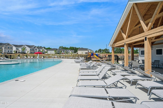 pool featuring a patio area and a residential view