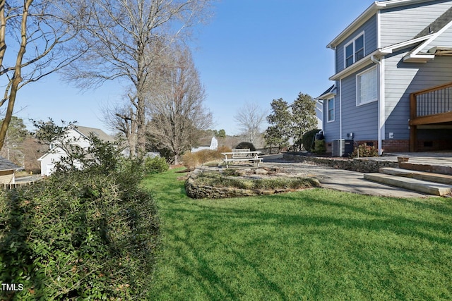 view of yard featuring cooling unit and a patio