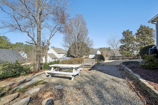 view of yard featuring a residential view, a patio area, and fence