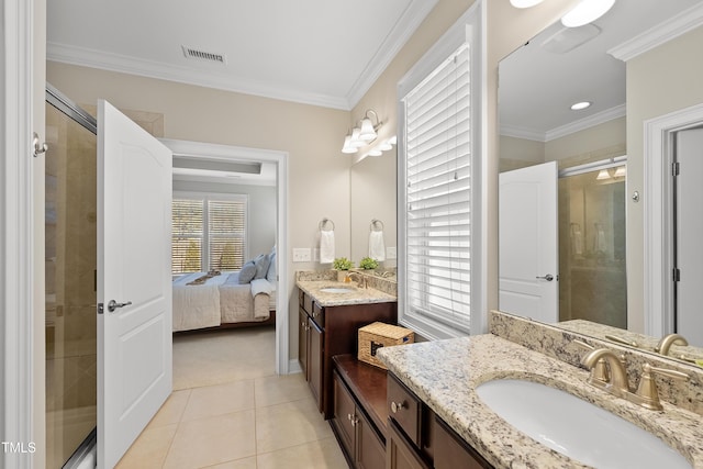 ensuite bathroom with ornamental molding, a stall shower, a sink, and tile patterned floors