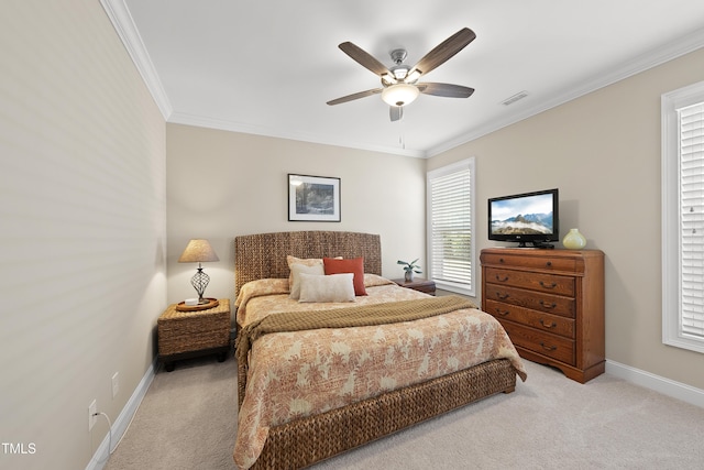 carpeted bedroom featuring ornamental molding, a ceiling fan, visible vents, and baseboards