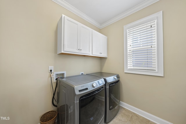 washroom featuring crown molding, light tile patterned floors, cabinet space, independent washer and dryer, and baseboards