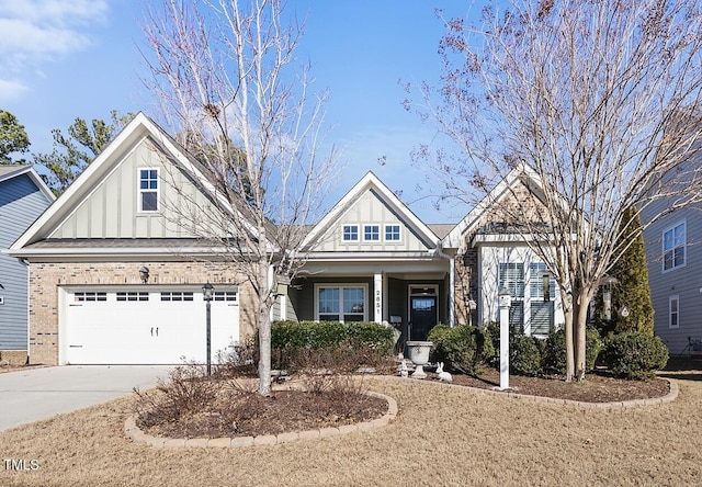 view of front of house featuring board and batten siding, brick siding, driveway, and an attached garage