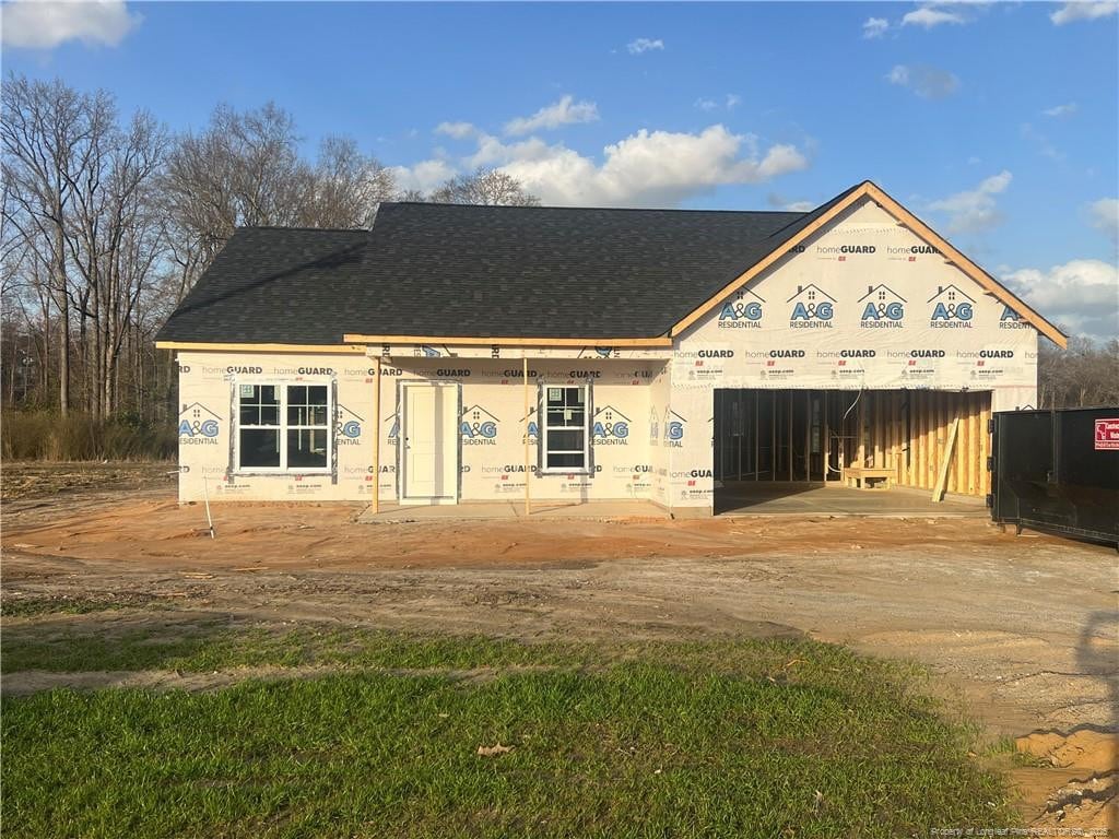 property in mid-construction featuring roof with shingles