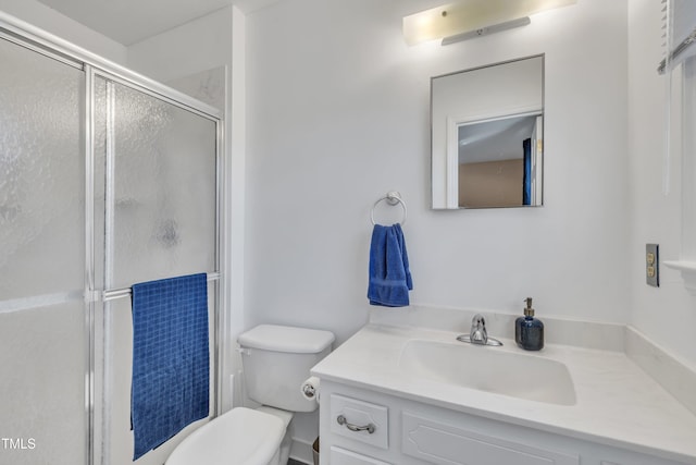 full bathroom featuring toilet, a shower stall, and vanity