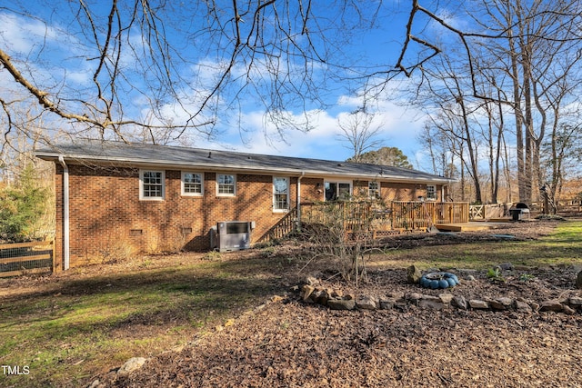 back of house with brick siding, crawl space, central AC unit, and a wooden deck