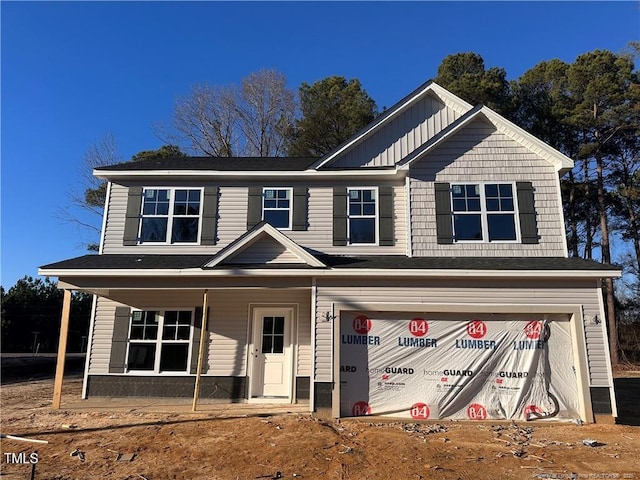 view of front of home with board and batten siding, covered porch, and a garage