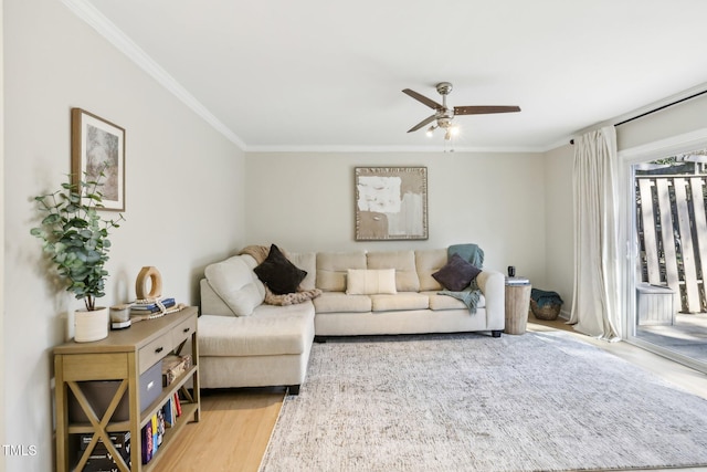 living area with a ceiling fan, crown molding, and wood finished floors