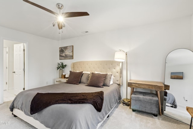 carpeted bedroom featuring visible vents and a ceiling fan