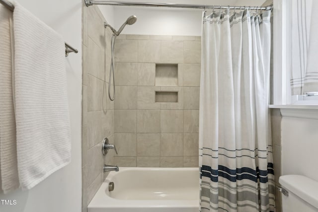 full bathroom with toilet and shower / bath combo with shower curtain