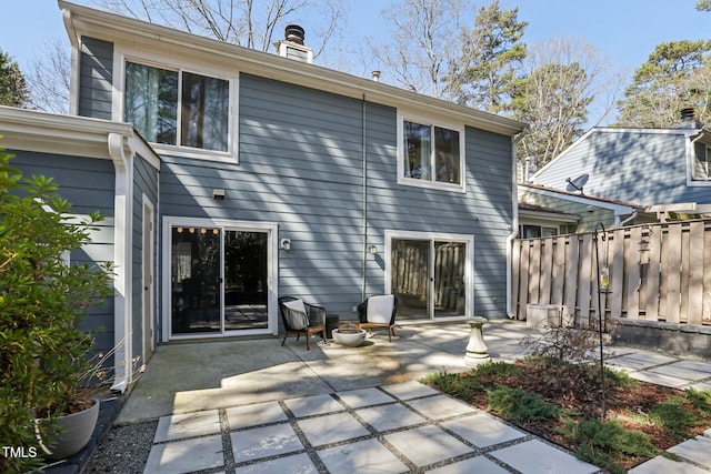 back of property with a patio area and fence