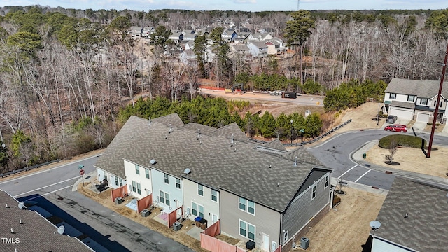 birds eye view of property with a forest view and a residential view