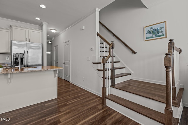 kitchen featuring dark wood-style floors, light stone counters, ornamental molding, stainless steel refrigerator with ice dispenser, and recessed lighting