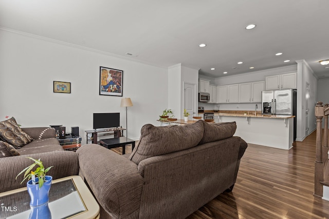 living room featuring visible vents, ornamental molding, dark wood-type flooring, and recessed lighting