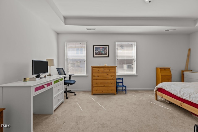 bedroom with multiple windows, visible vents, and light colored carpet