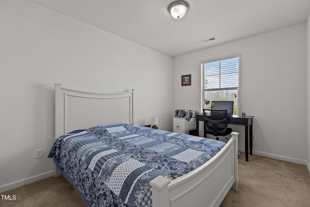 carpeted bedroom featuring baseboards and visible vents