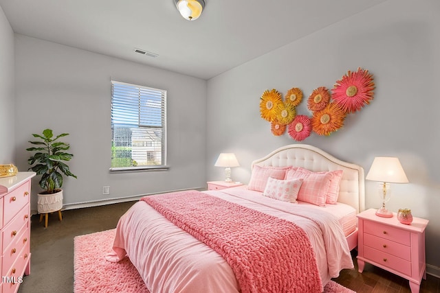 bedroom with visible vents and baseboards