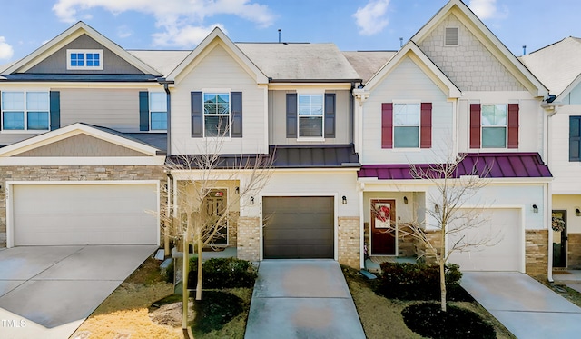 multi unit property with concrete driveway, brick siding, and a standing seam roof