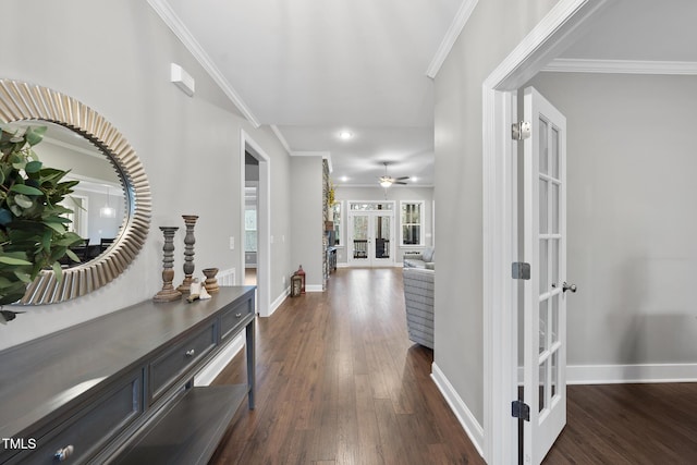 corridor with dark wood finished floors, french doors, crown molding, and baseboards