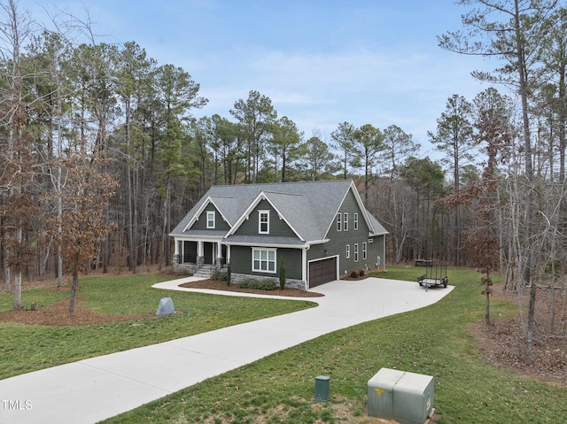 craftsman-style home with a porch, concrete driveway, a front yard, a garage, and stone siding