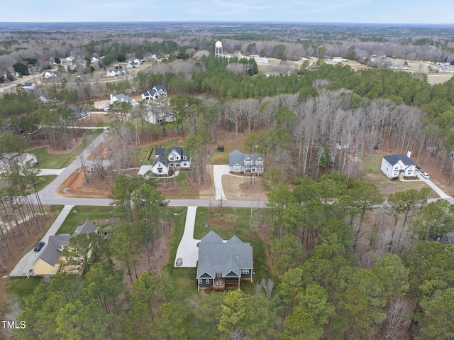 drone / aerial view featuring a forest view